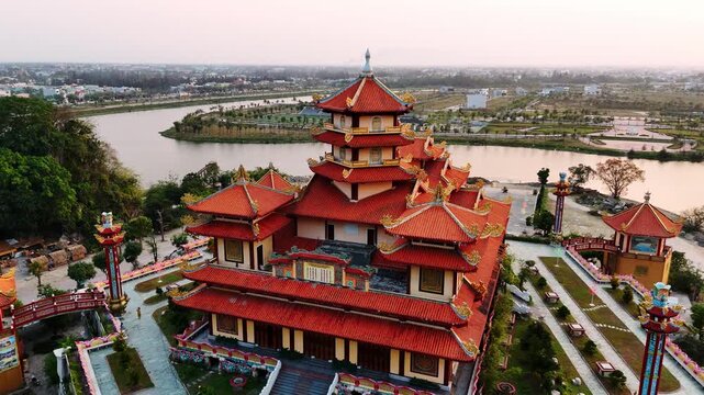 Aerial view of famous buddhist pagoda in da nang, vietnam with the city skyline during a magical golden hour sunset, quan the am pagoda
