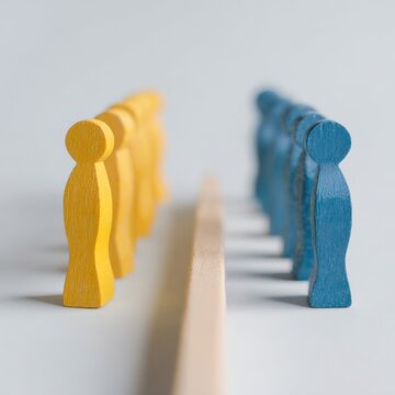 Two opposing rows of yellow and blue wooden figures separated by a narrow divider symbolizing team division rivalry and negotiation in concept visualization