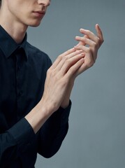 Marfan Syndrome: Professional photography, tall person with exceptionally long fingers and thin frame, elegant portrait, focus on hand proportions, neutral studio background.