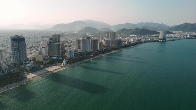Aerial view of nha trang city skyline with its sandy beach and turquoise water in vietnam during sunset
