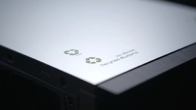 Close-up of eco-friendly laptop with green computing logo on screen, symbolizing sustainable technology and net zero data