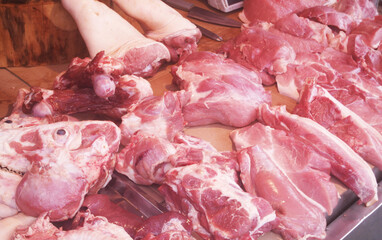 Many pieces of pork on table at market close up