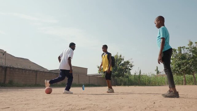 Casual match black teammates compete dribbling quick passes foot battles dusty pitch sunny sky neighborhood rivalry playful competition attacker defender roles emerge celebration after skillful move