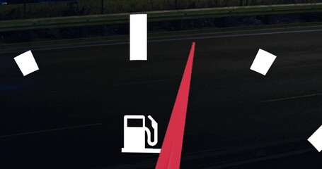 Displaying fuel-gauge graphic with white pump icon, tick marks and red needle on roadside at night