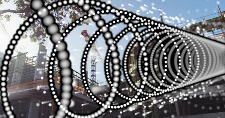 Framing right foreground, dotted spiral leading to site with crane, scaffold, branches, highlights