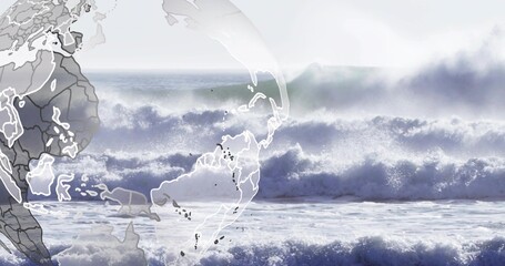 Crashing breaking waves and surf filling open sea with foam and spray, faint globe showing maps