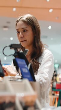 Transgender woman laughing while checking out at a cashier desk