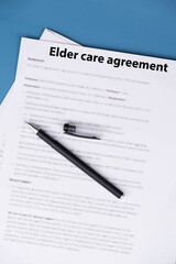 Elder care agreement contract on desk, legal document for senior caregiving services, family support and healthcare responsibility concept.