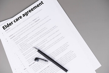 Obraz premium Elder care agreement contract on desk, legal document for senior caregiving services, family support and healthcare responsibility concept.