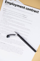 Employment contract document on office desk, legal agreement for hiring, job offer, and professional business relationship concept.