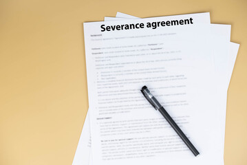 Obraz premium Severance agreement document on office desk, legal contract detailing terms of job termination and severance pay, symbol of closure, protection, and career transition in professional life.