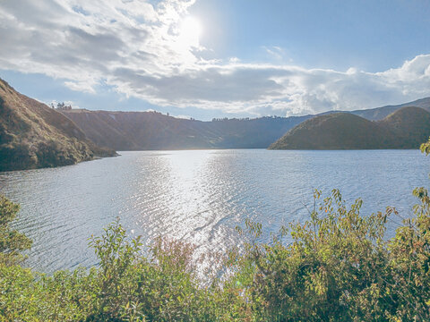 Cotacachi, Ecuador &ndash; November 5, 2025: Cuicocha Lagoon in the Ecuadorian Andes, surrounded by vegetation. In the background, the majestic Cotacachi Volcano with its summit hidden among the clouds.