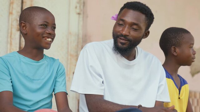 Family joyful moment. Father and children enjoy playful times with warm sunlight shining. Loving family bond captured during cheerful outdoor afternoon with playful teasing and smiles