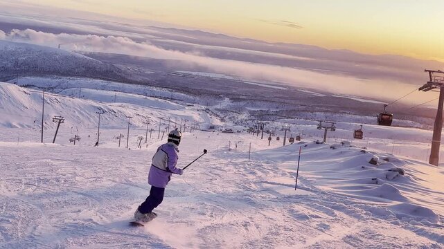 The atmosphere is cinematic and peaceful: glowing sunset light, drifting mountain fog, and a ski lift moving slowly in the background.
