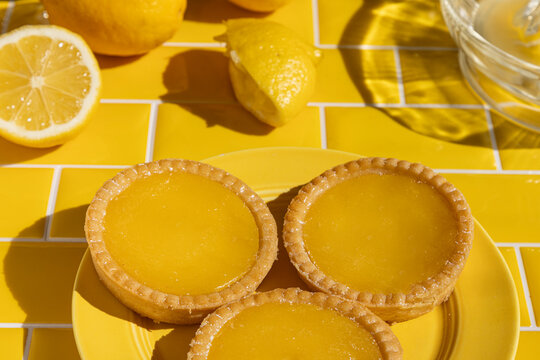 Lemon tarts on yellow tile