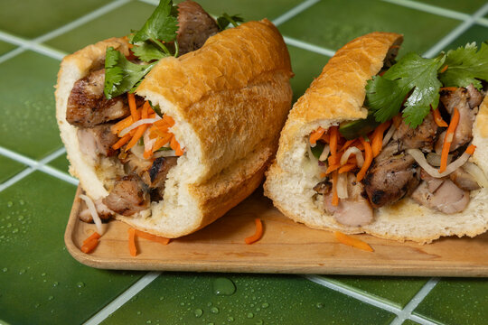 Chicken Banh Mi sandwich on green tile