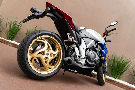 Tricolor Honda CB1000R rear three quarters low angle, Naked sport bike wide angle closeup shot