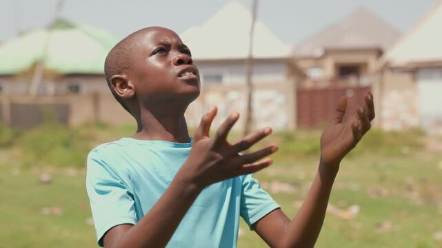 Boy perfecting soccer juggling skills. Serious young player honing football juggling and technique skills. Aspiring young sportsman focusing intensely on improving soccer juggling ability outdoors
