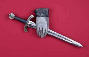 Templar sword isolated on red background