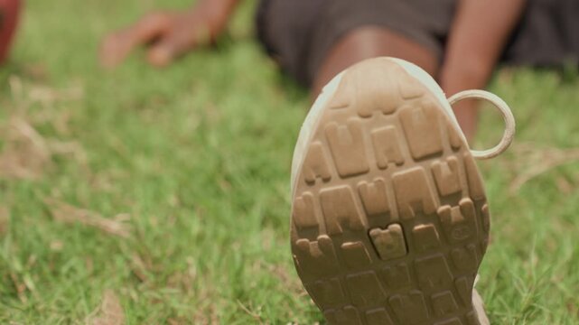 Sneaker tread detail in sunlight. Closeup of worn sneaker sole after outdoor workout activity. Footwear worn during training captures outdoor leisure with casual style and natural light