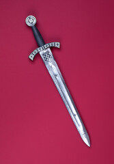 Templar sword isolated on red background