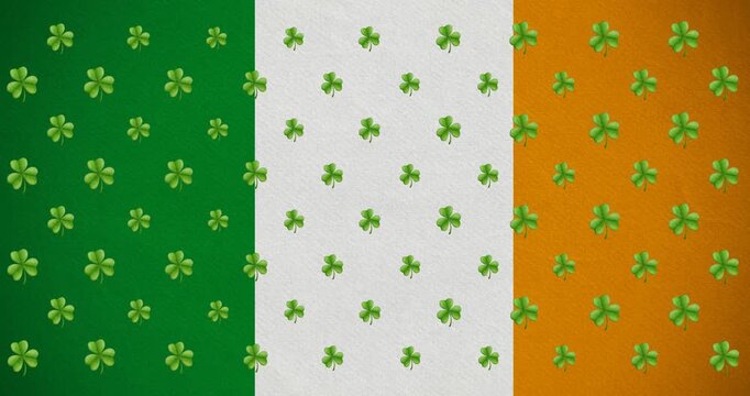 Digital animation of multiple clover leaves moving against irish flag
