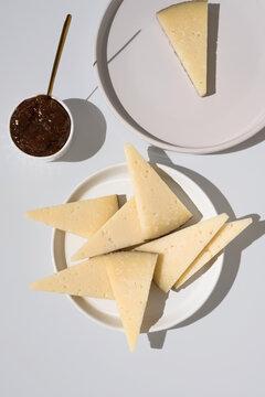 Manchego cheese with fig jam on white plate