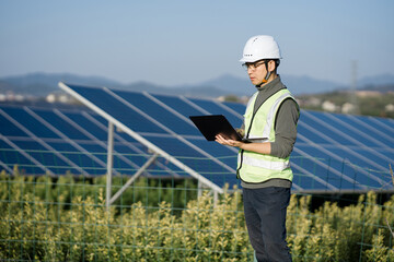 Engineer conducting on-site inspection of solar panels at a photovoltaic power station