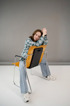 Teenager sitting casually on a modern chair