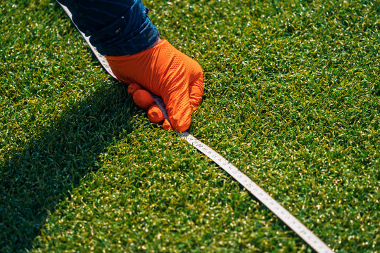 Measuring tape on soccer field during renovation process