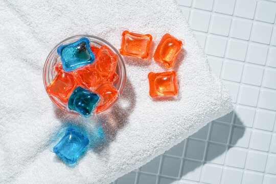 Laundry capsules on white towel with sunlight