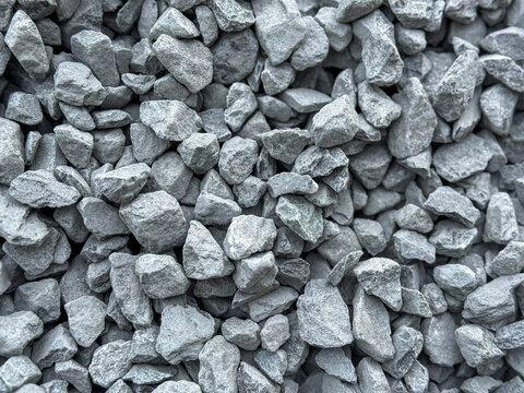 Pile of grey stones and gravel background texture