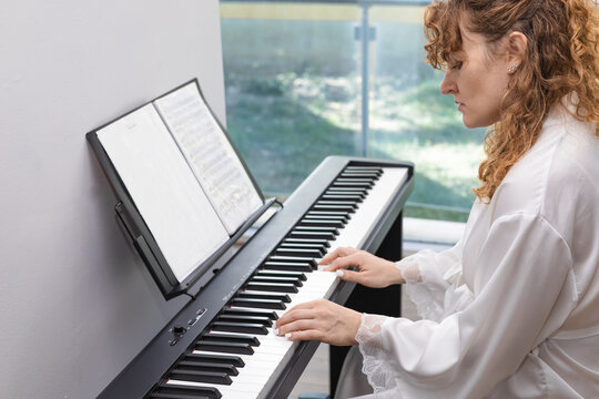 Woman enjoying piano playing in peaceful setting