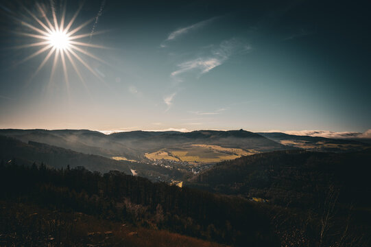 Bright sunshine over a valley amidst hilly landscape, springtime, view from the Borberg towards Brilon-Wald or Elleringhausen, hike in the Sauerland region, the Briloner Kammweg trail 59929 Brilon