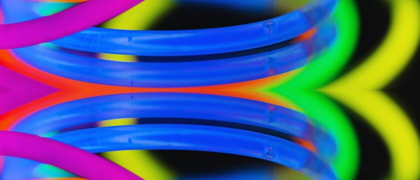 Colorful glow sticks arranged in circular motion with vibrant hues and dynamic shapes creating an engaging visual display.
