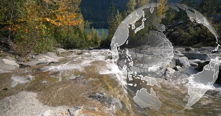 Fototapeta premium Flowing mountain stream making ripples, cascading over bedrock in alpine valley, globe overlay