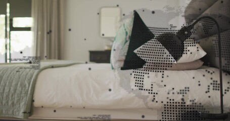 Showing bed at home, with folded green quilt, patterned black pillow, curved lamp, halftone dots