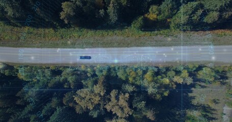 Naklejka premium Driving dark car traveling along two-lane rural road with grassy verge and telemetry overlay