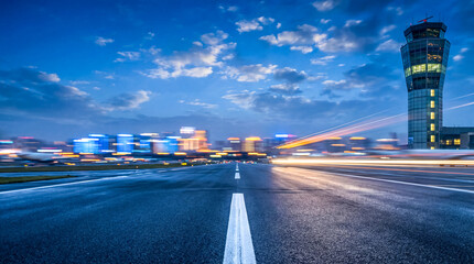Expansive Airport Runway Underneath a Dynamic Evening Sky with a Control Tower
