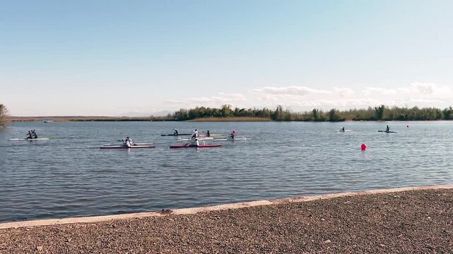 Athletes training during a canoe marathon competition on a lake
