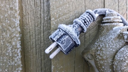 Frost covers electrical plug on a chilly morning outdoors in winter