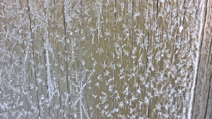 Frost covers wooden surface early in the morning during winter season