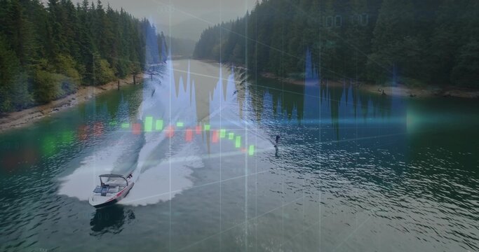 Cutting motorboat towing wakeboard rider in vest on treed lake pulling tow rope leaving wake charts