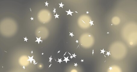 Naklejka premium Scattering white five-pointed stars creating depth on grey-beige canvas with warm golden bokeh