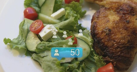 Showing white plate with lettuce, cucumber, tomatoes, feta cubes and roast thigh on table, badge 50 © vectorfusionart