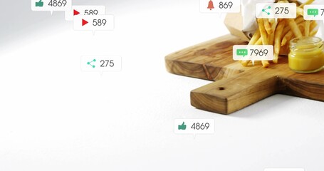 Displaying wood board holding paper-cone of fries with sauce jar on white table, icons, copy space © vectorfusionart