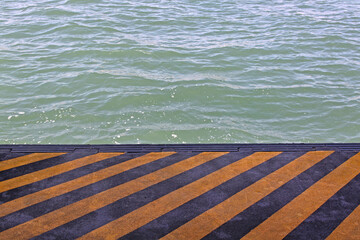 Yellow and Black Stripes Pattern at Pier Dock Pontoon Italy © markobe