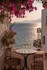 Fototapeta premium Mediterranean balcony with whitewashed walls and blooming bougainvillea overlooks the sea, table set with two wine glasses. Romantic coastal view at golden hour, peaceful and sunlit.
