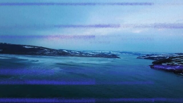 Coastal inlet water showing shifting ripples while colored pixel bands appearing from signal glitch