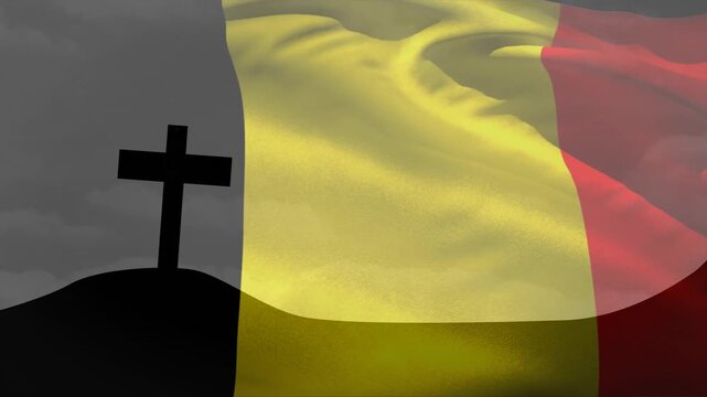 Wind starting, Belgian tricolor flag waving over silhouetted hill cross, honoring memorial